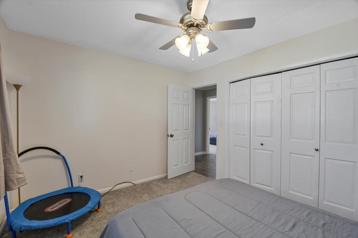 275 Alexander Drive Rantoul, IL 61866 - Photo 4 of 24 a view of a bedroom with a bed and a chandelier fan