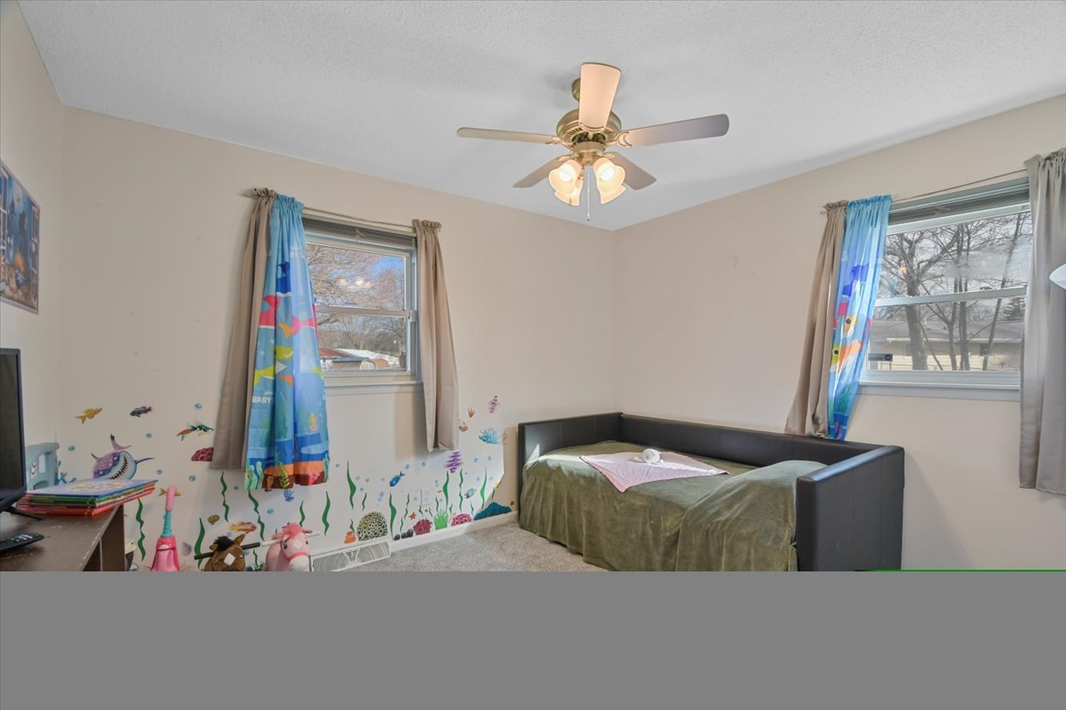 275 Alexander Drive Rantoul, IL 61866 - Photo 5 of 24 a bedroom with a bed and a chandelier