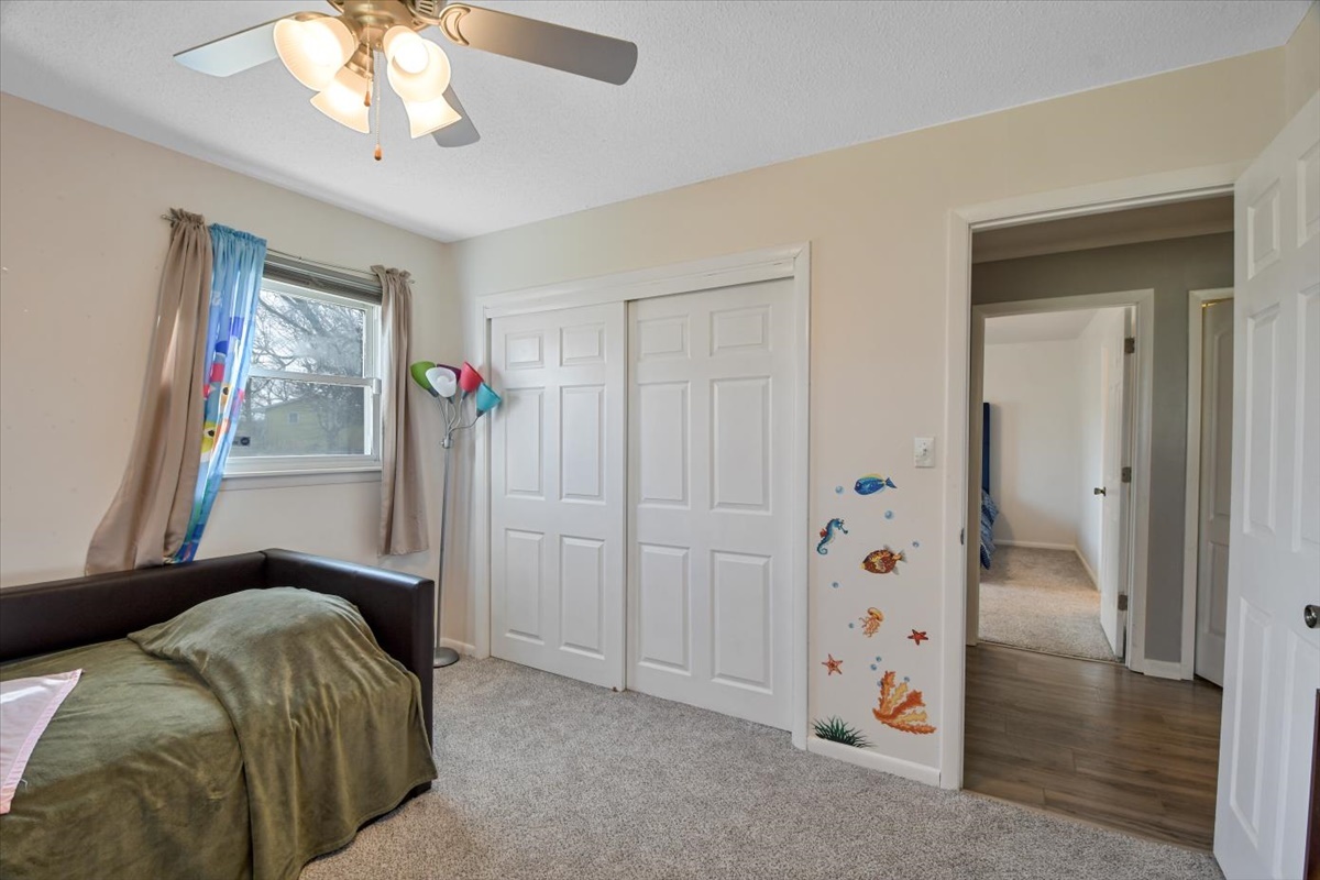 275 Alexander Drive Rantoul, IL 61866 - Photo 6 of 24 a bedroom with a bed and a chandelier