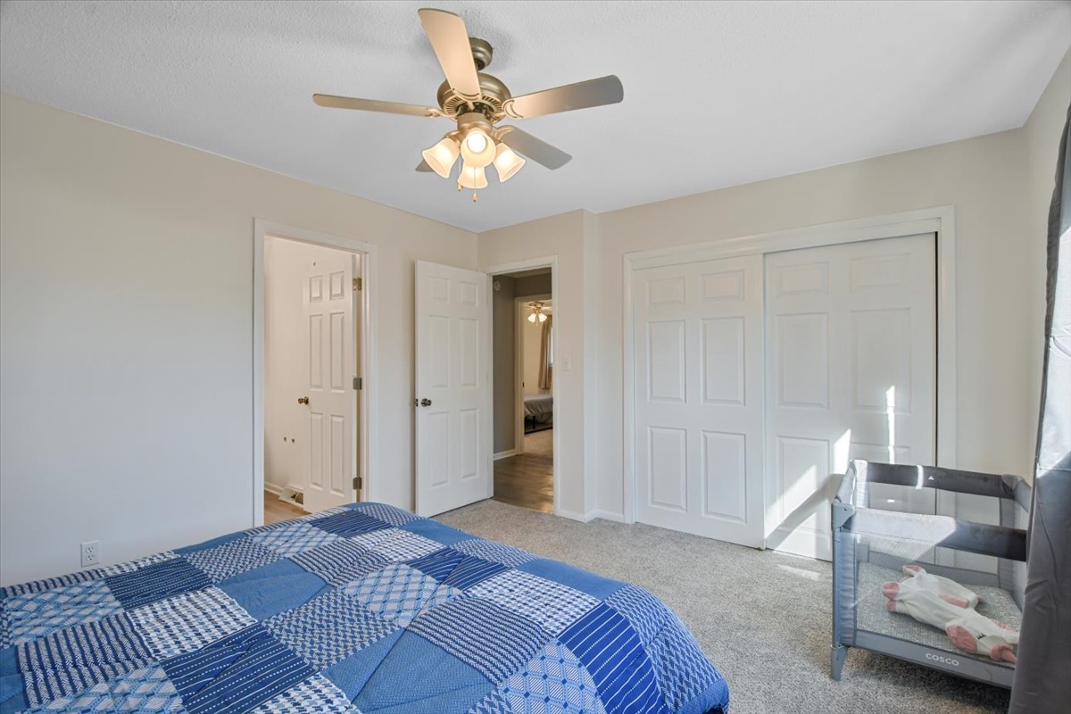 275 Alexander Drive Rantoul, IL 61866 - Photo 8 of 24 a bedroom with a bed and a chandelier