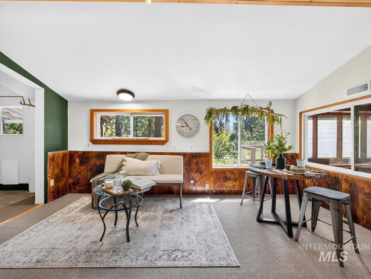 6 Rattlesnake Road Boise City, ID 83716 - Photo 21 of 50 Recreation room featuring wood-paneled wainscoting, natural wood window frames, and exposed wood ceiling beams