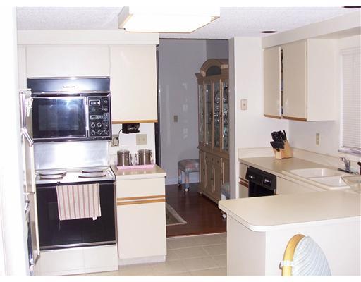 7727 La Mirada Drive, Unit 118 Boca Raton, FL 33433 - Photo 5 of 16 a kitchen with stainless steel appliances a stove a sink and a refrigerator