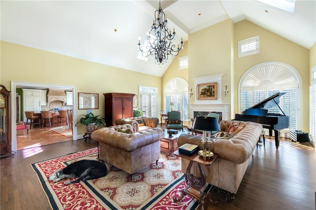 3460 Paces Valley Road Northwest Atlanta, GA 30327 - Photo 16 of 45 a living room with fireplace furniture and a chandelier