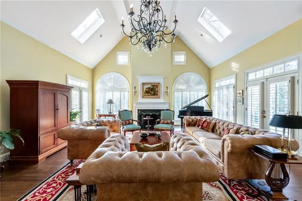 a living room with fireplace furniture and a large window