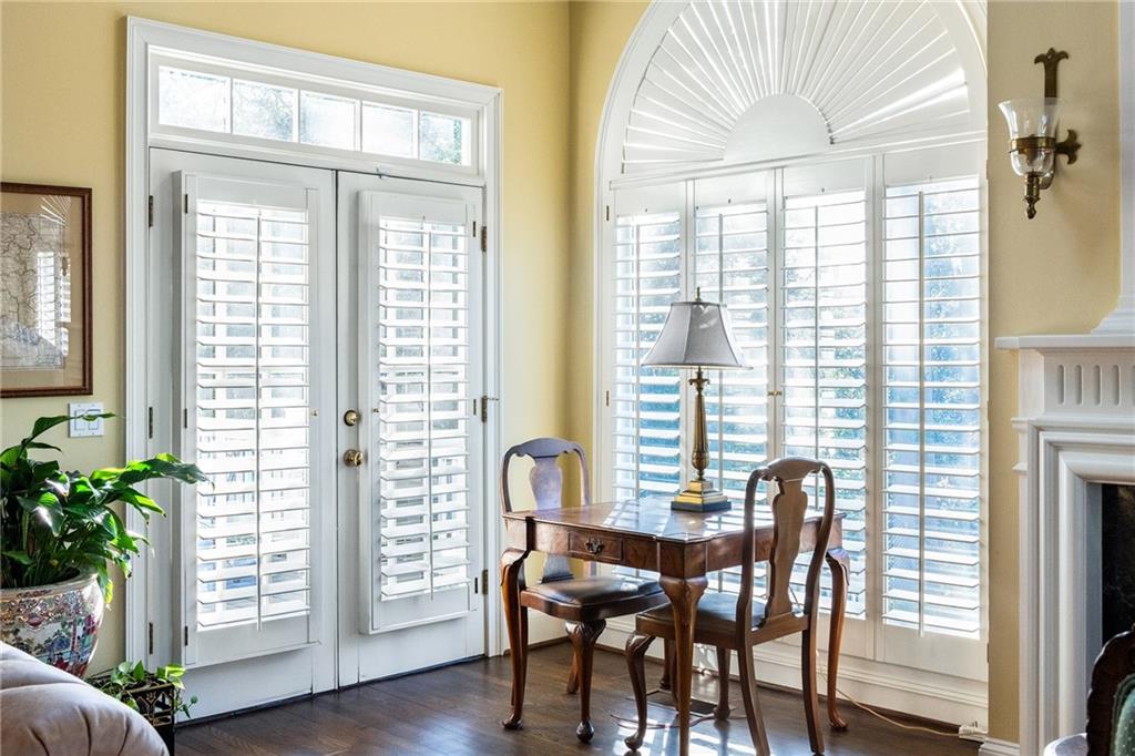 3460 Paces Valley Road Northwest Atlanta, GA 30327 - Photo 19 of 45 a view of a dining room with furniture and wooden floor