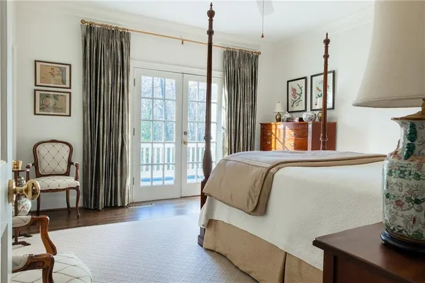 a bedroom with a bed wooden floor and a window