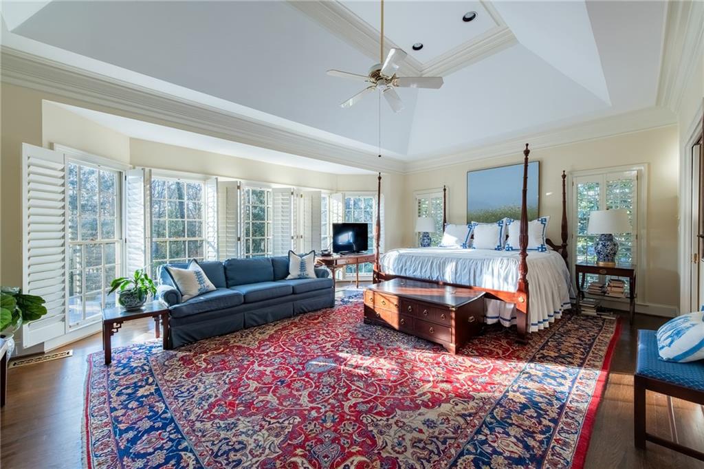 3460 Paces Valley Road Northwest Atlanta, GA 30327 - Photo 23 of 45 a spacious bedroom with a bed a couch and potted plant with the dresser