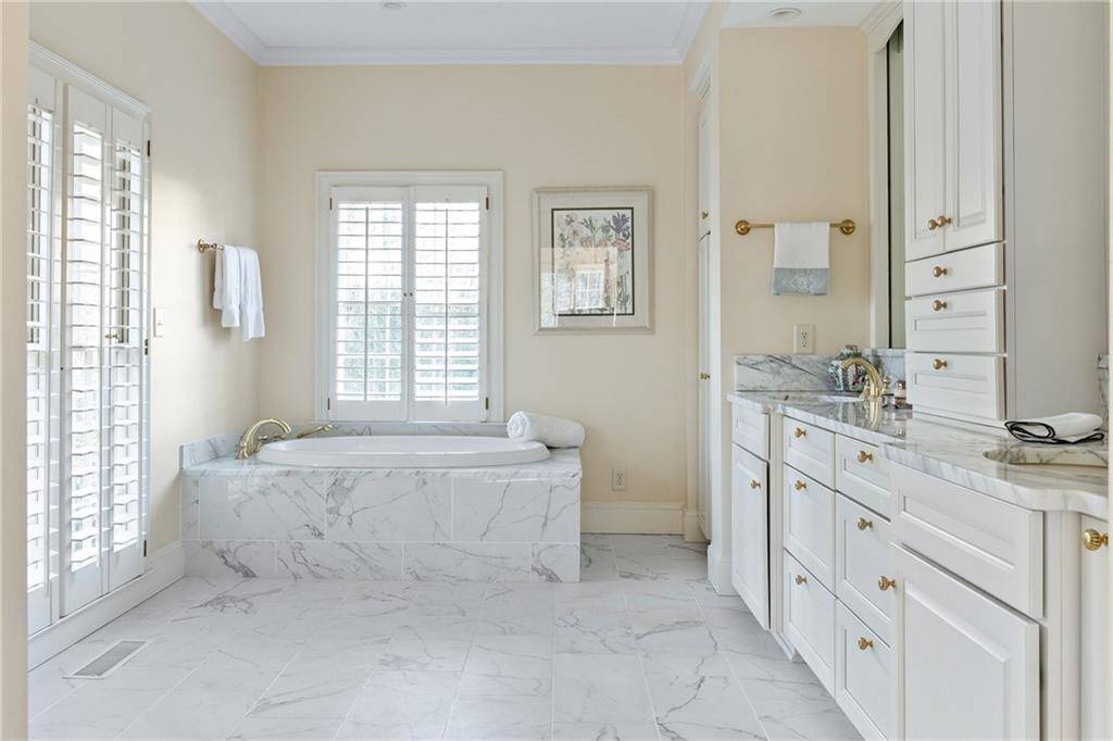 3460 Paces Valley Road Northwest Atlanta, GA 30327 - Photo 24 of 45 a spacious en suite bathroom with a granite countertop double vanity sink a mirror and a bathtub