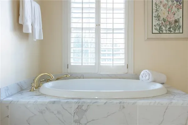 a bath tub sitting in a bathroom next to a window