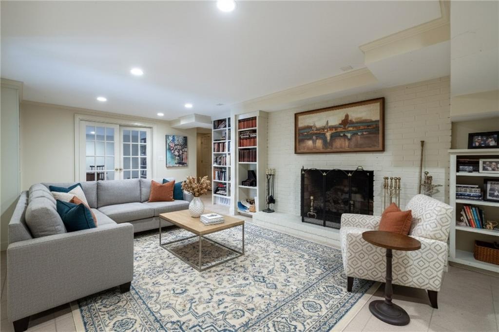 3460 Paces Valley Road Northwest Atlanta, GA 30327 - Photo 28 of 45 a living room with furniture and a fireplace