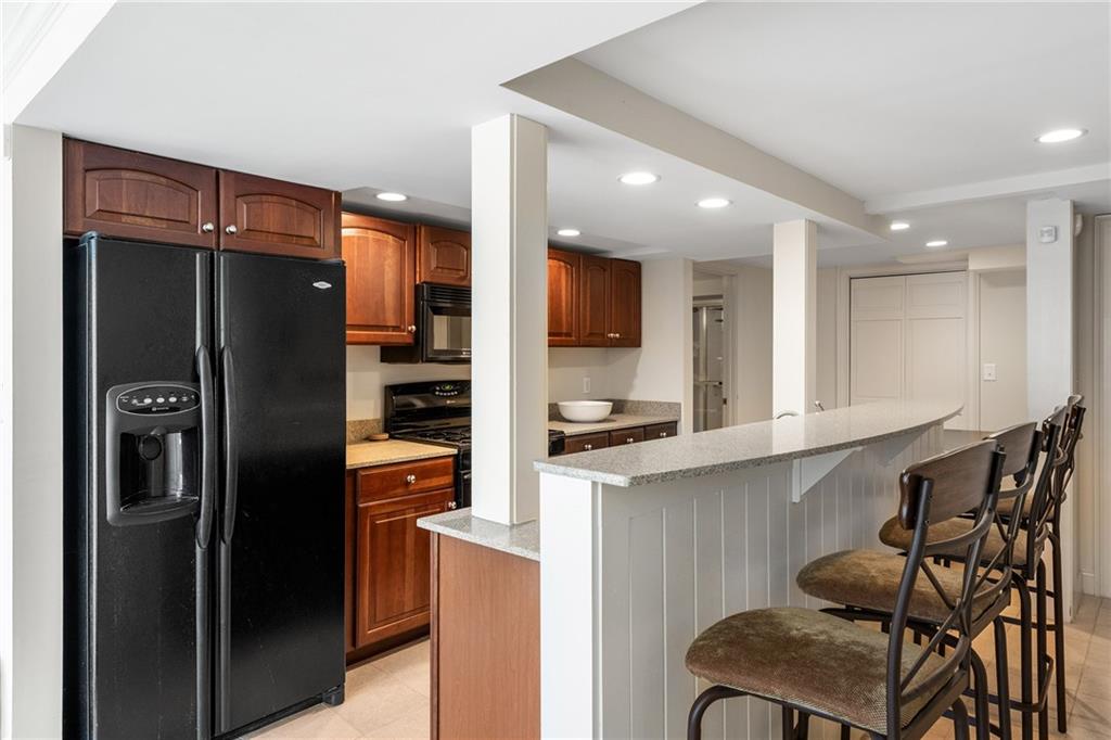 3460 Paces Valley Road Northwest Atlanta, GA 30327 - Photo 30 of 45 a kitchen with stainless steel appliances granite countertop a refrigerator and a stove top oven
