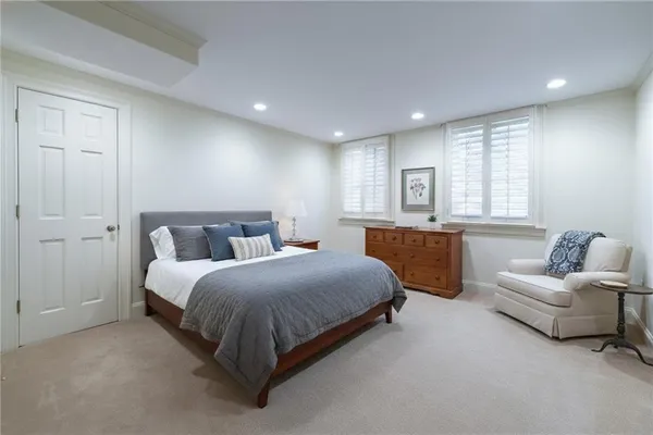 a spacious bedroom with a bed and furniture