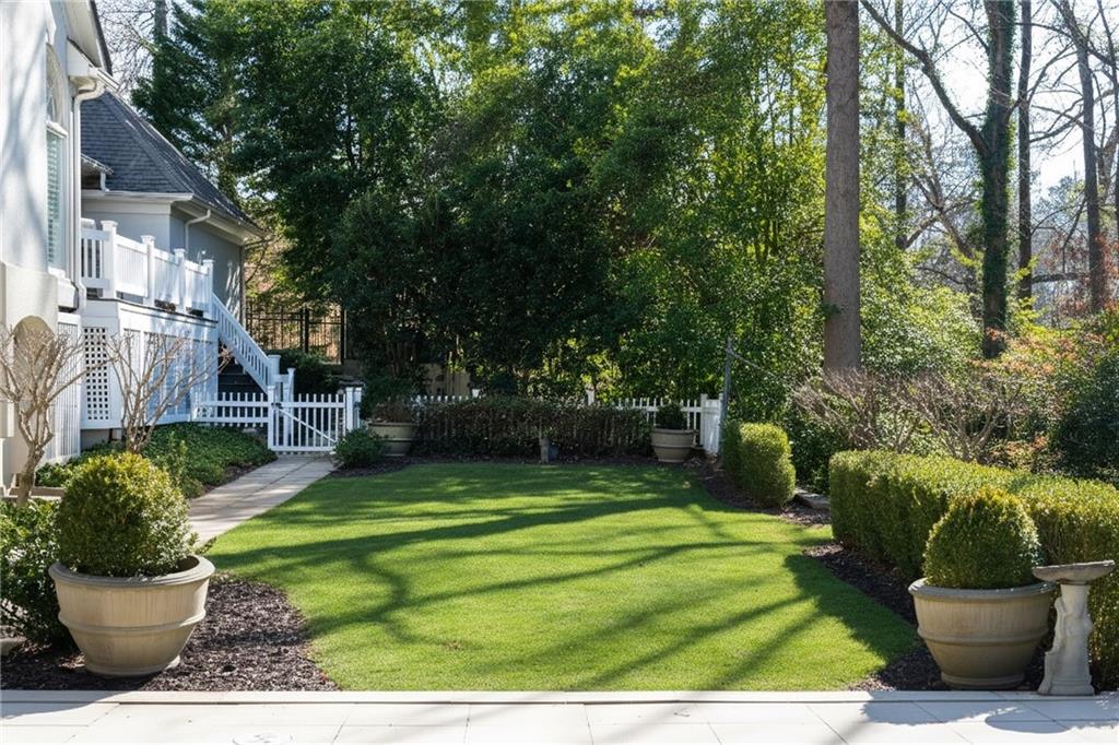 3460 Paces Valley Road Northwest Atlanta, GA 30327 - Photo 38 of 45 a view of a white house with a yard and a fountain