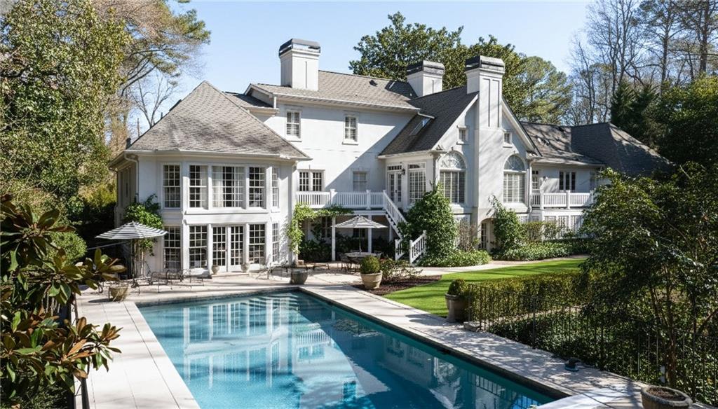3460 Paces Valley Road Northwest Atlanta, GA 30327 - Photo 39 of 45 a front view of a house with swimming pool and porch