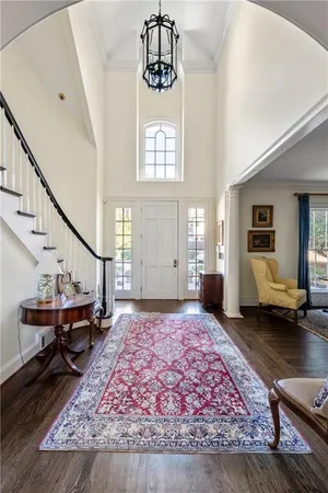 a living room with furniture rug and a window