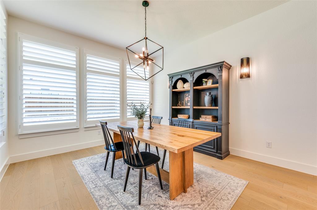 660 Neale Street Prosper, TX 75078 - Photo 12 of 40 a view of a dining room with a table and chairs