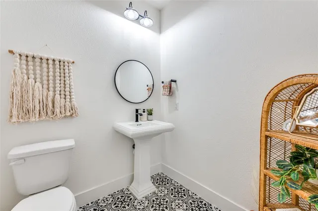 a bathroom with a sink toilet and a mirror