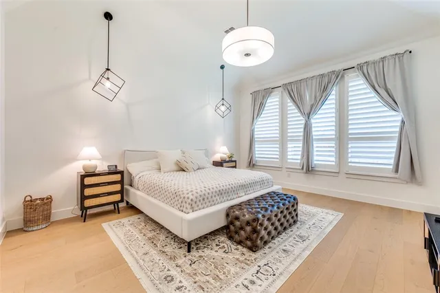 a bedroom with a bed and a chandelier