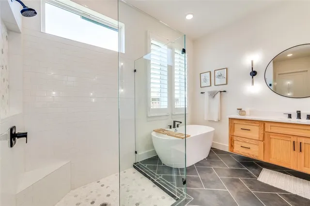a spacious bathroom with a double vanity sink a mirror and a bathtub