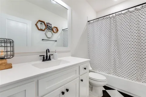 a bathroom with a sink a toilet and a mirror