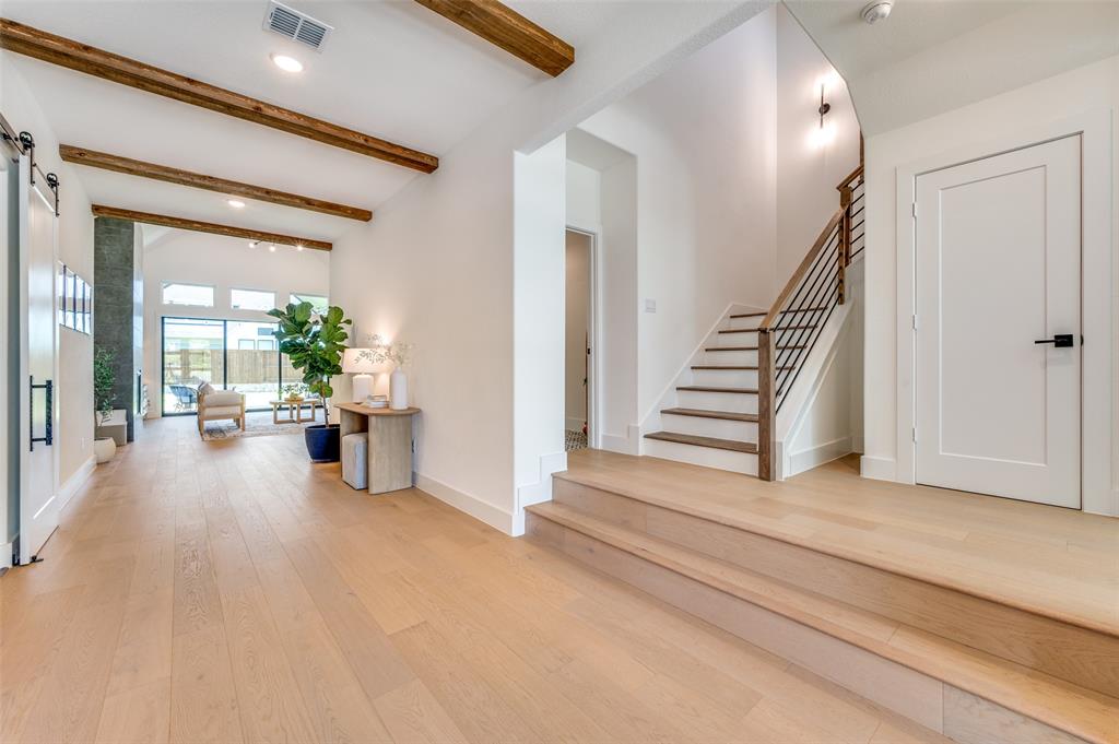 660 Neale Street Prosper, TX 75078 - Photo 3 of 40 a view of a hallway with wooden floor and windows