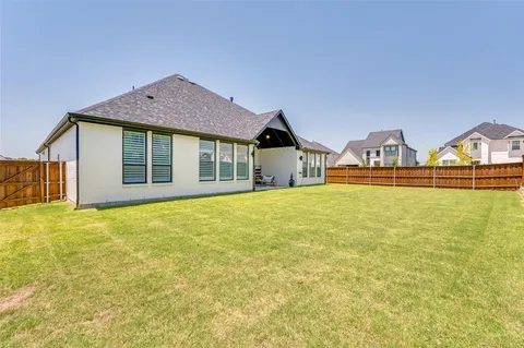 a view of a house with a yard and garage