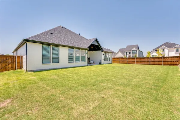 a view of a house with a yard and garage