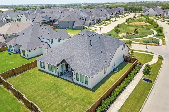an aerial view of a house with a swimming pool