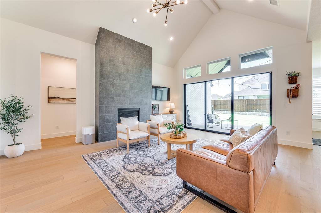 660 Neale Street Prosper, TX 75078 - Photo 5 of 40 a living room with fireplace furniture and a large window