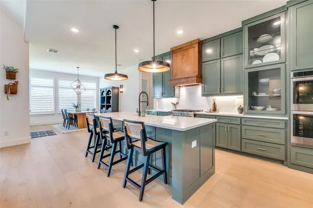 a kitchen with stainless steel appliances granite countertop sink stove and cabinets