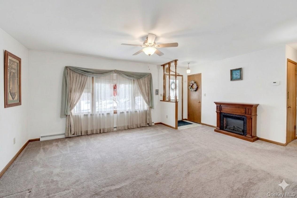 17 Last Road Middletown, NY 10941 - Photo 4 of 23 an empty room with windows and fireplace