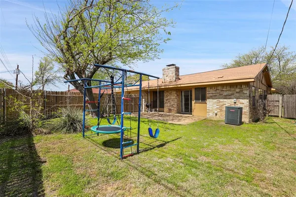 a view of a house with backyard porch and sitting area