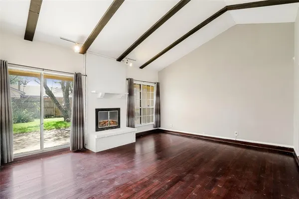 a view of a room with wooden floor and fireplace