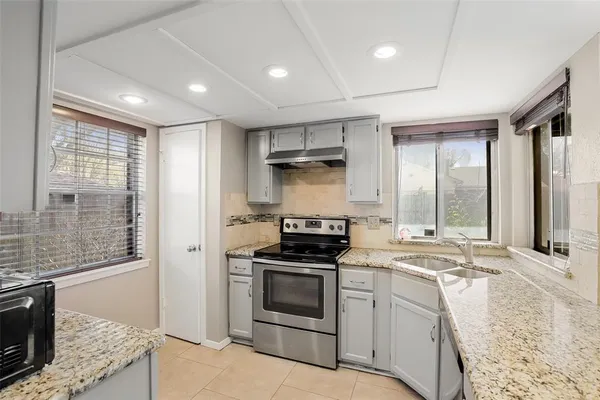 a kitchen that has a sink and a stove