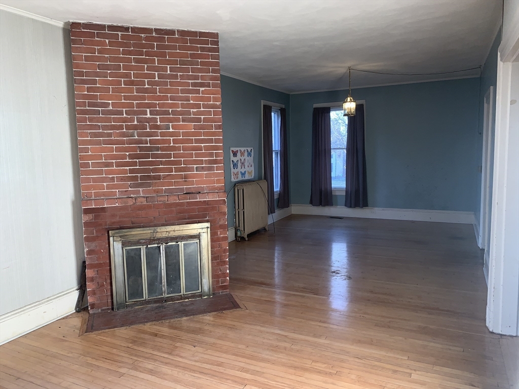 72 Green Street Athol, MA 01331 - Photo 10 of 36 a view of an empty room with wooden floor and a fireplace