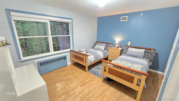 a bedroom with two beds and a window