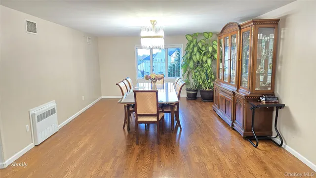 a dining room with furniture window and wooden floor
