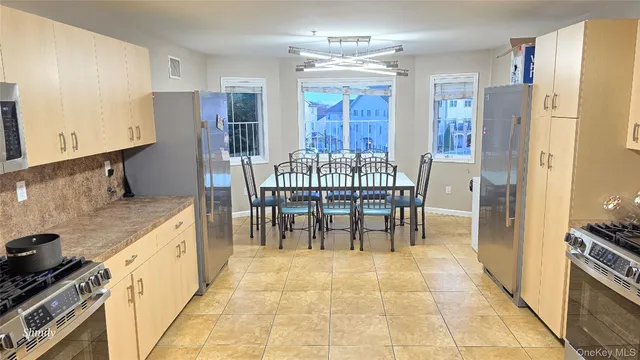 a kitchen with stainless steel appliances granite countertop a refrigerator and a stove top oven