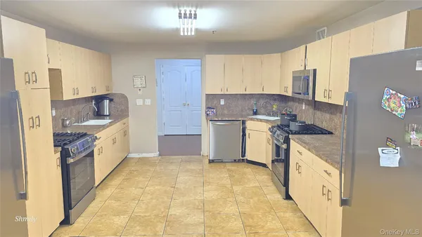 a kitchen with a stove top oven sink and refrigerator