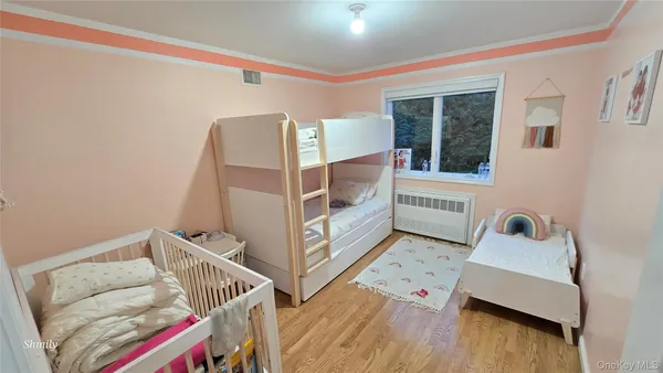 a bedroom with two beds and a window