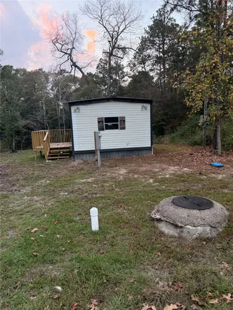 a backyard of a house with table and chairs