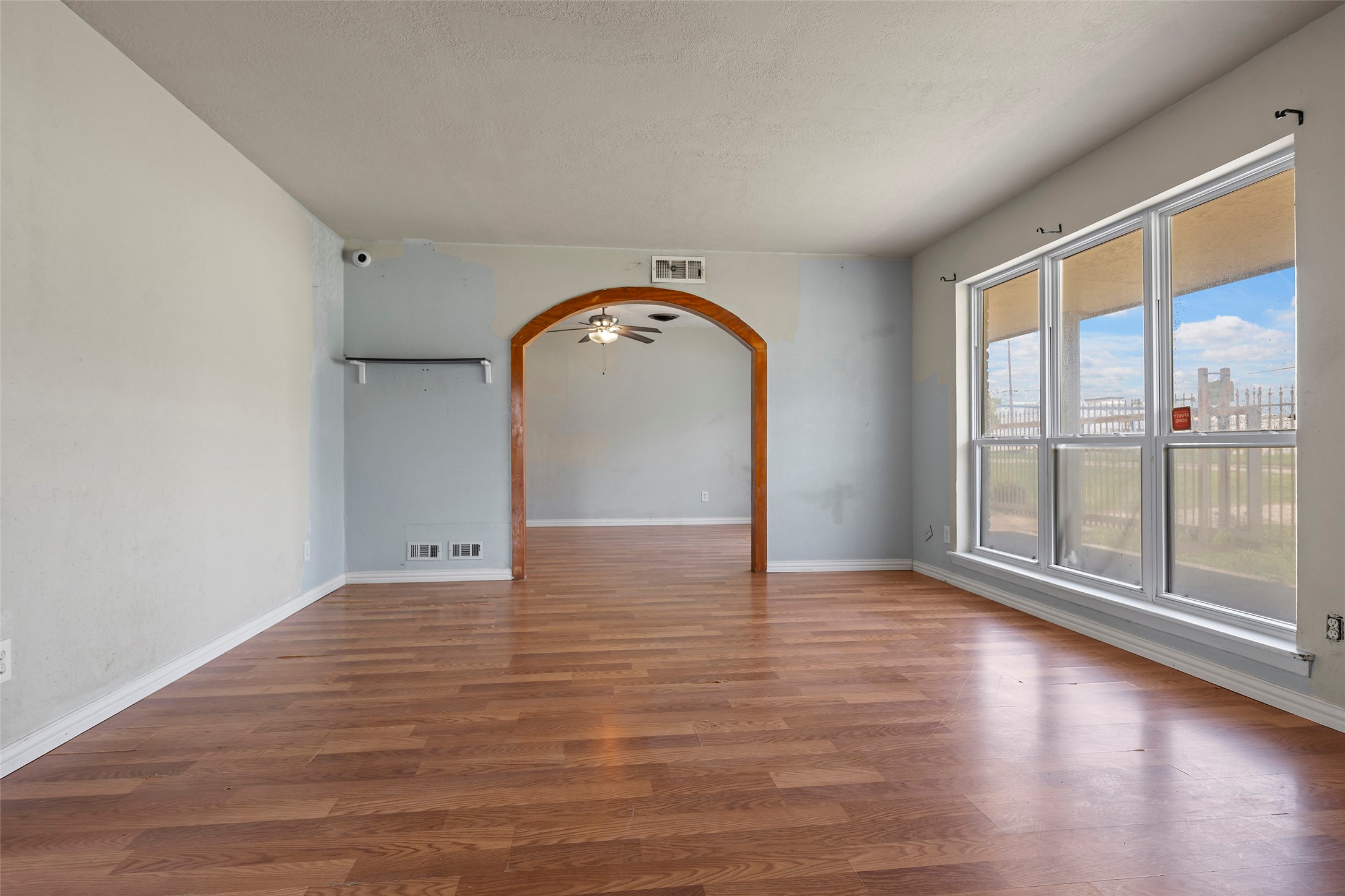 822 Aldine Mail Rte Road Houston, TX 77037 - Photo 25 of 44 a view of empty room with wooden floor and fan