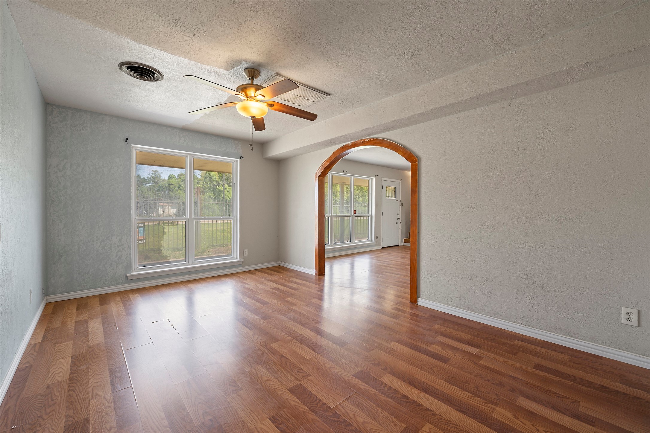 822 Aldine Mail Rte Road Houston, TX 77037 - Photo 26 of 44 a view of empty room with wooden floor and fan