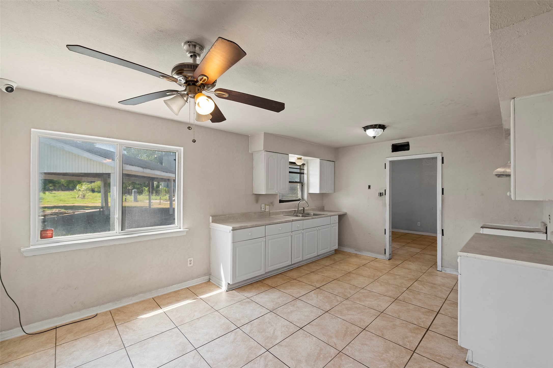 822 Aldine Mail Rte Road Houston, TX 77037 - Photo 31 of 44 a kitchen with a refrigerator and a sink