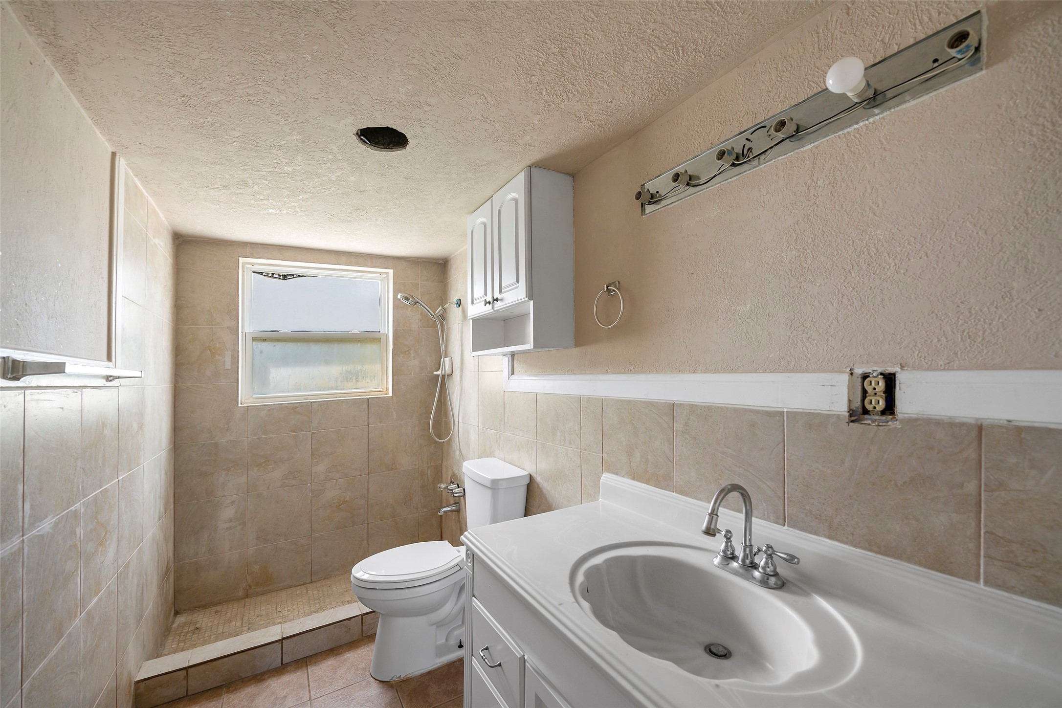 822 Aldine Mail Rte Road Houston, TX 77037 - Photo 34 of 44 a bathroom with a sink a toilet and shower