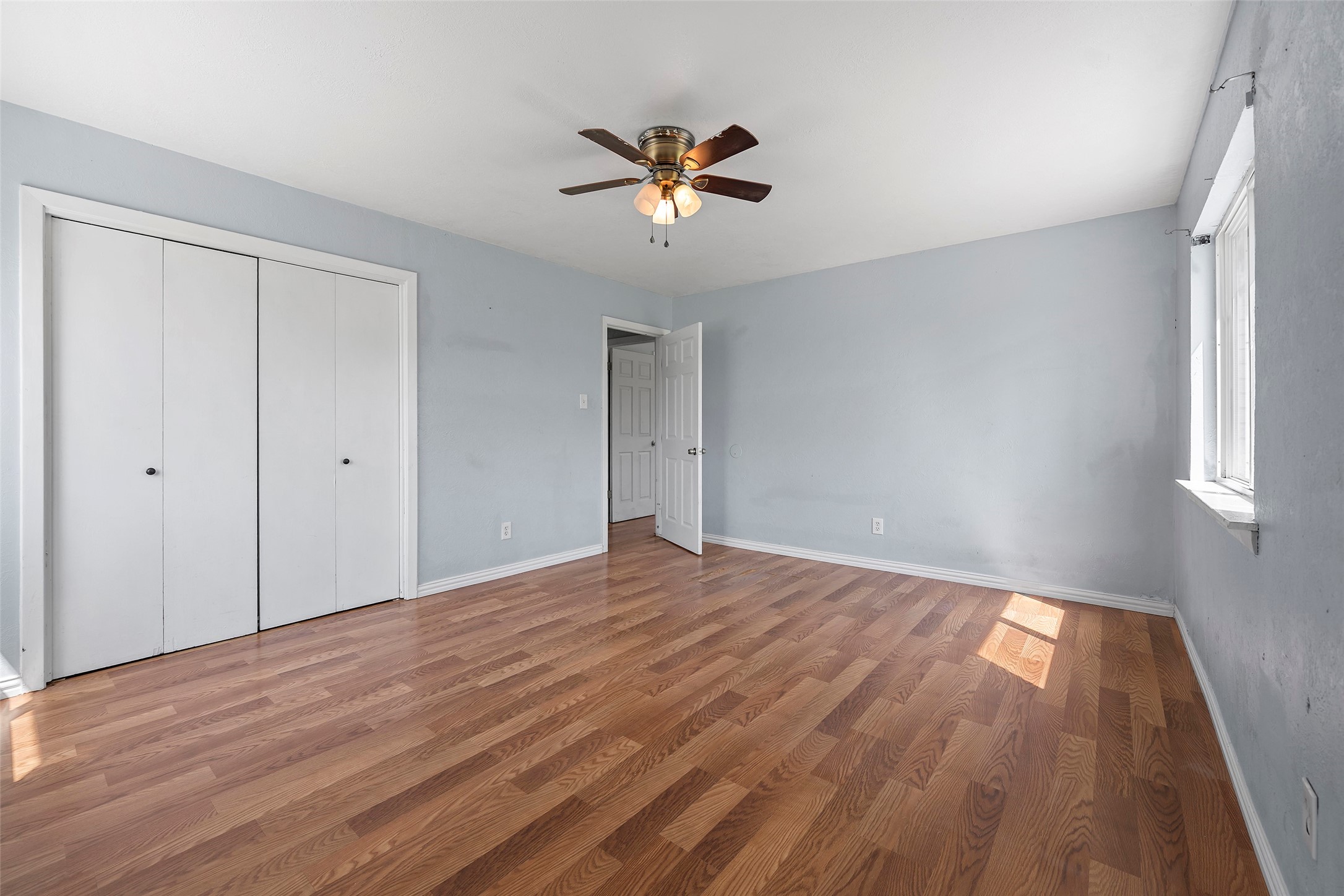 822 Aldine Mail Rte Road Houston, TX 77037 - Photo 36 of 44 a view of an empty room with wooden floor and a window