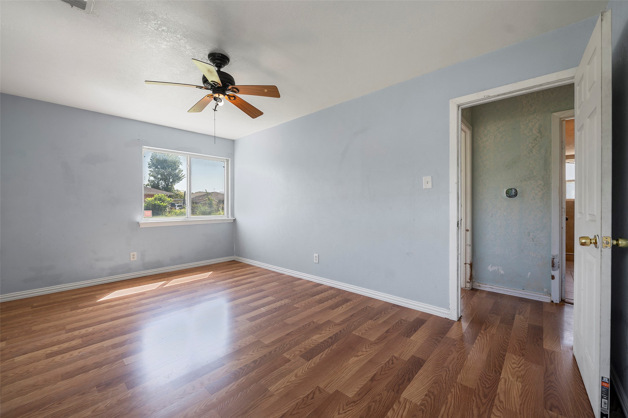 822 Aldine Mail Rte Road Houston, TX 77037 - Photo 38 of 44 wooden floor in an empty room with a window