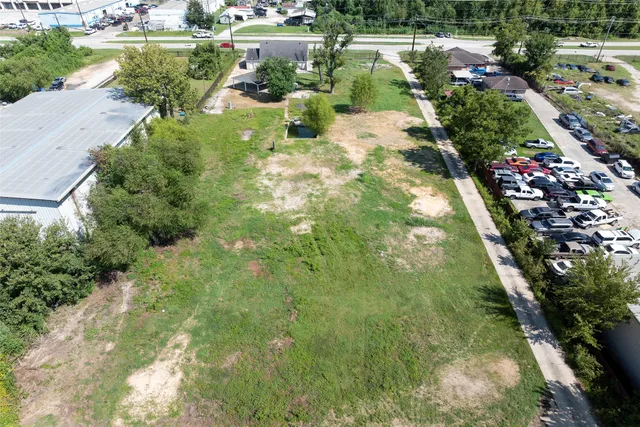 an aerial view of a residential houses with outdoor space
