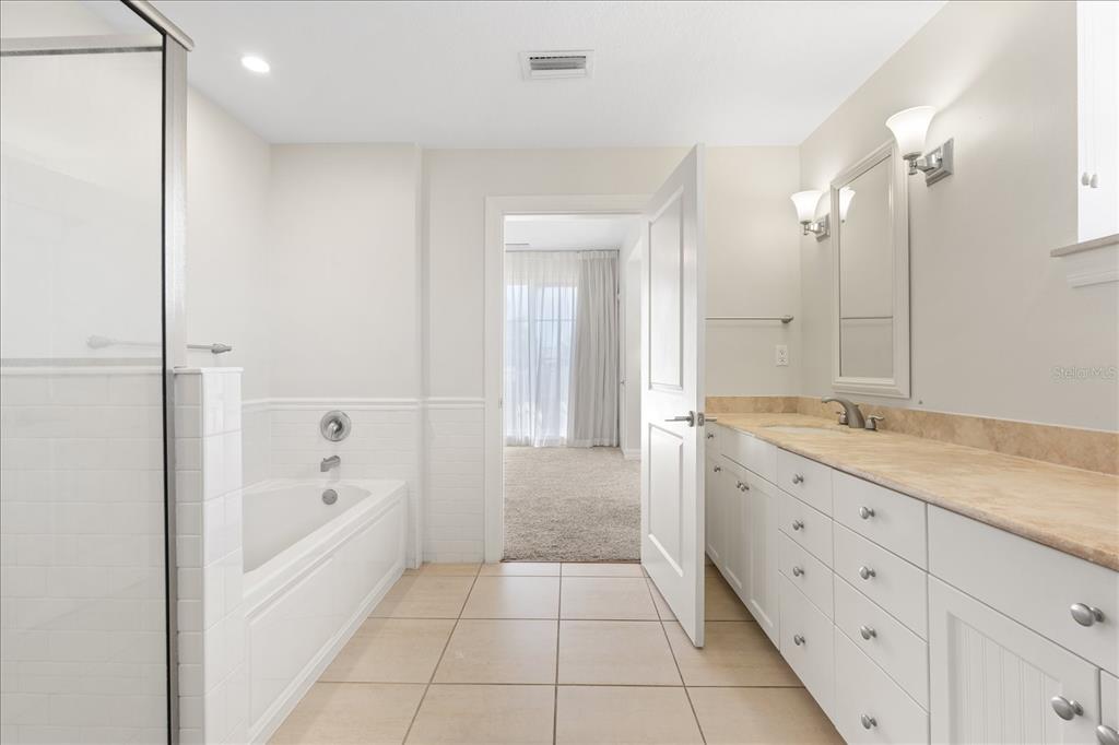536 Bahia Beach Boulevard, Unit 431C Ruskin, FL 33570 - Photo 12 of 27 a bathroom with a granite countertop sink a mirror and a bathtub