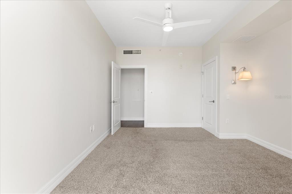 536 Bahia Beach Boulevard, Unit 431C Ruskin, FL 33570 - Photo 14 of 27 an empty room with a ceiling fan and a window